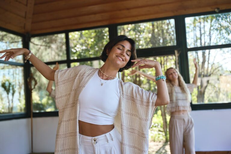 happy-young-women-dancing-together-during-healing-holistic-therapy-practice--768x512