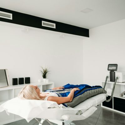 relaxed-woman-enjoying-in-pressotherapy-treatment-at-wellness-center-